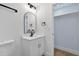 Bathroom features a white vanity with black hardware, arched mirror, and modern lighting at 1503 Granite State Ct, Mount Dora, FL 32757