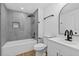 Newly renovated bathroom with sleek gray tile, modern fixtures, and a bathtub-shower combo at 1503 Granite State Ct, Mount Dora, FL 32757