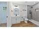 Modern bathroom with gray tile, walk-in shower, and floating vanity at 1503 Granite State Ct, Mount Dora, FL 32757