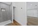 Bathroom features modern walk-in shower, sleek fixtures, and an adjacent shelved closet at 1503 Granite State Ct, Mount Dora, FL 32757