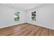 Bright bedroom with sleek wood flooring, natural light, and windows with outside views at 1503 Granite State Ct, Mount Dora, FL 32757
