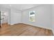 A bright bedroom with wood floors and white walls at 1503 Granite State Ct, Mount Dora, FL 32757