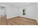 Bright, minimalist bedroom has sleek, wood-look floors and a view from the window at 1503 Granite State Ct, Mount Dora, FL 32757