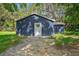 Back view of home showing a simple white door and a blue paint job at 1503 Granite State Ct, Mount Dora, FL 32757