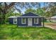 Charming home boasts a welcoming porch and well-maintained lawn at 1503 Granite State Ct, Mount Dora, FL 32757