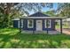 Inviting home with a covered porch and well-manicured front lawn at 1503 Granite State Ct, Mount Dora, FL 32757