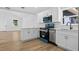 Bright kitchen with white cabinetry, stainless steel appliances, and modern countertops at 1503 Granite State Ct, Mount Dora, FL 32757