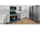 Modern kitchen featuring stainless steel appliances, white cabinets, and quartz countertops at 1503 Granite State Ct, Mount Dora, FL 32757