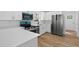 Bright kitchen with white cabinetry, stainless steel appliances, and modern countertops at 1503 Granite State Ct, Mount Dora, FL 32757