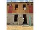 Townhome under construction, showcasing blockwork and framing on a sunny day at 15052 Grove Lake Dr, Winter Garden, FL 34787