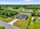 Beautiful single-story home boasts a dark roof, a large lawn and is surrounded by lush greenery at 15684 Sw 37Th Cir, Ocala, FL 34473