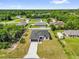 Aerial view of a home with black roof and a backyard with white vinyl fence at 15684 Sw 37Th Cir, Ocala, FL 34473