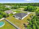 A large backyard featuring a white fence line, a grassy lawn and a small concrete patio at 15684 Sw 37Th Cir, Ocala, FL 34473