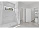 Luxurious bathroom featuring white marble-look tile and glass shower at 15684 Sw 37Th Cir, Ocala, FL 34473