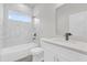 Modern bathroom featuring white marble-look tile and a black faucet and fixtures at 15684 Sw 37Th Cir, Ocala, FL 34473