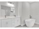 Modern bathroom featuring double sink vanity with soaker tub at 15684 Sw 37Th Cir, Ocala, FL 34473
