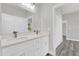 Bathroom featuring double sinks with modern faucets and a bright overhead light at 15684 Sw 37Th Cir, Ocala, FL 34473