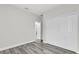 Bright bedroom featuring wood-look flooring and a closet with white bi-fold doors at 15684 Sw 37Th Cir, Ocala, FL 34473