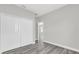 Bright bedroom featuring wood-look flooring and a closet with white bi-fold doors at 15684 Sw 37Th Cir, Ocala, FL 34473