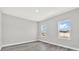 Bright bedroom featuring wood-look flooring and two windows overlooking trees at 15684 Sw 37Th Cir, Ocala, FL 34473
