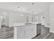 Kitchen island with stainless steel dishwasher, sink and faucet, and quartz countertop at 15684 Sw 37Th Cir, Ocala, FL 34473