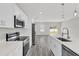 Bright kitchen boasting white cabinets, stainless appliances, and a view to the backyard at 15684 Sw 37Th Cir, Ocala, FL 34473
