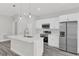 Well-lit kitchen with stainless steel appliances, quartz countertop island, and gray wood-look flooring at 15684 Sw 37Th Cir, Ocala, FL 34473