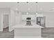Bright kitchen featuring a large island, stainless steel appliances, and modern pendant lighting at 15684 Sw 37Th Cir, Ocala, FL 34473