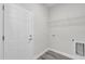 Neat laundry room with shelving and connections, next to a white door at 15684 Sw 37Th Cir, Ocala, FL 34473