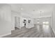 Open-concept living room showcasing the kitchen with island, stainless steel appliances and plank flooring throughout at 15684 Sw 37Th Cir, Ocala, FL 34473