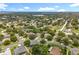 An aerial shot of a quiet neighborhood featuring mature trees, varied home styles, and scenic views at 1602 Presidio Dr, Clermont, FL 34711