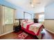 Charming bedroom with a window, wood accenting, and hardwood floors at 1602 Presidio Dr, Clermont, FL 34711