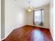 Cozy bedroom featuring hardwood floors, a ceiling fan, and a window for natural light at 1602 Presidio Dr, Clermont, FL 34711