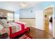 Stylized bedroom featuring blue accent walls, hardwood floors, and a comfortable bed at 1602 Presidio Dr, Clermont, FL 34711