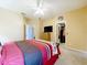 Bedroom with ceiling fan, TV, walk-in closet, and an access door to another room at 1602 Presidio Dr, Clermont, FL 34711