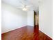 Comfortable bedroom with hardwood floors, a ceiling fan, and an attached room at 1602 Presidio Dr, Clermont, FL 34711