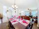 Dining room with view into the living room featuring an elegant dining table at 1602 Presidio Dr, Clermont, FL 34711