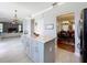Open concept kitchen with island and marble countertop next to living and dining rooms at 1602 Presidio Dr, Clermont, FL 34711
