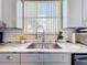 Modern Kitchen sink with granite countertop, subway tile backsplash, and grey cabinets at 1602 Presidio Dr, Clermont, FL 34711