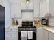 Modern kitchen design with stainless steel appliances and gray cabinets at 1602 Presidio Dr, Clermont, FL 34711
