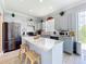 Modern kitchen featuring stainless steel appliances and an island with marble countertop at 1602 Presidio Dr, Clermont, FL 34711