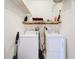 Laundry room featuring a washer, dryer, and shelving at 1602 Presidio Dr, Clermont, FL 34711