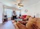 Living room showcasing sofas, modern table, and natural light from the windows at 1602 Presidio Dr, Clermont, FL 34711