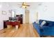 Bright living room with a ceiling fan, blue couch, wooden floors and a desk for work space at 1602 Presidio Dr, Clermont, FL 34711