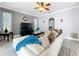 Comfortable living room featuring stylish decor, ceiling fan, and neutral color palette at 1602 Presidio Dr, Clermont, FL 34711