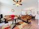 Cozy living room with sofas, glass table, and a view into the dining area at 1602 Presidio Dr, Clermont, FL 34711