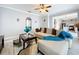 Well-lit living room featuring open layout, tile floors, and modern ceiling fan at 1602 Presidio Dr, Clermont, FL 34711