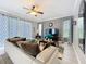 Bright living room with large windows, ceiling fan, and comfortable seating arrangement at 1602 Presidio Dr, Clermont, FL 34711