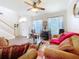 Bright living room with staircase, large windows, and cozy seating area at 1602 Presidio Dr, Clermont, FL 34711
