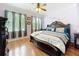 Spacious main bedroom features light walls, hardwood floors, ceiling fan, and large windows at 1602 Presidio Dr, Clermont, FL 34711